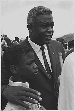 Former National Baseball League player, Jackie Robinson with his son during the Civil Rights March on Washington, D.C.